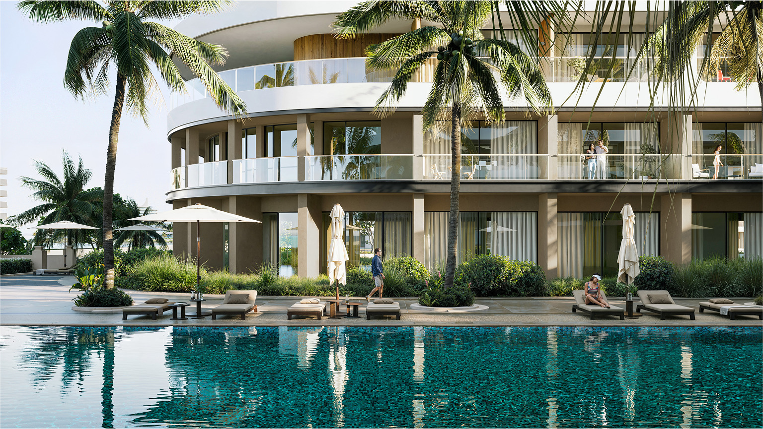 Luxury Palm Beach resort pool and building with guests relaxing.