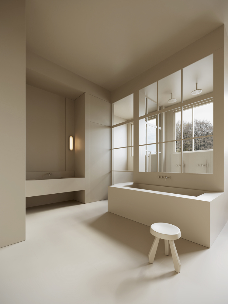 Minimalist beige bathroom with freestanding tub, sink, and window.