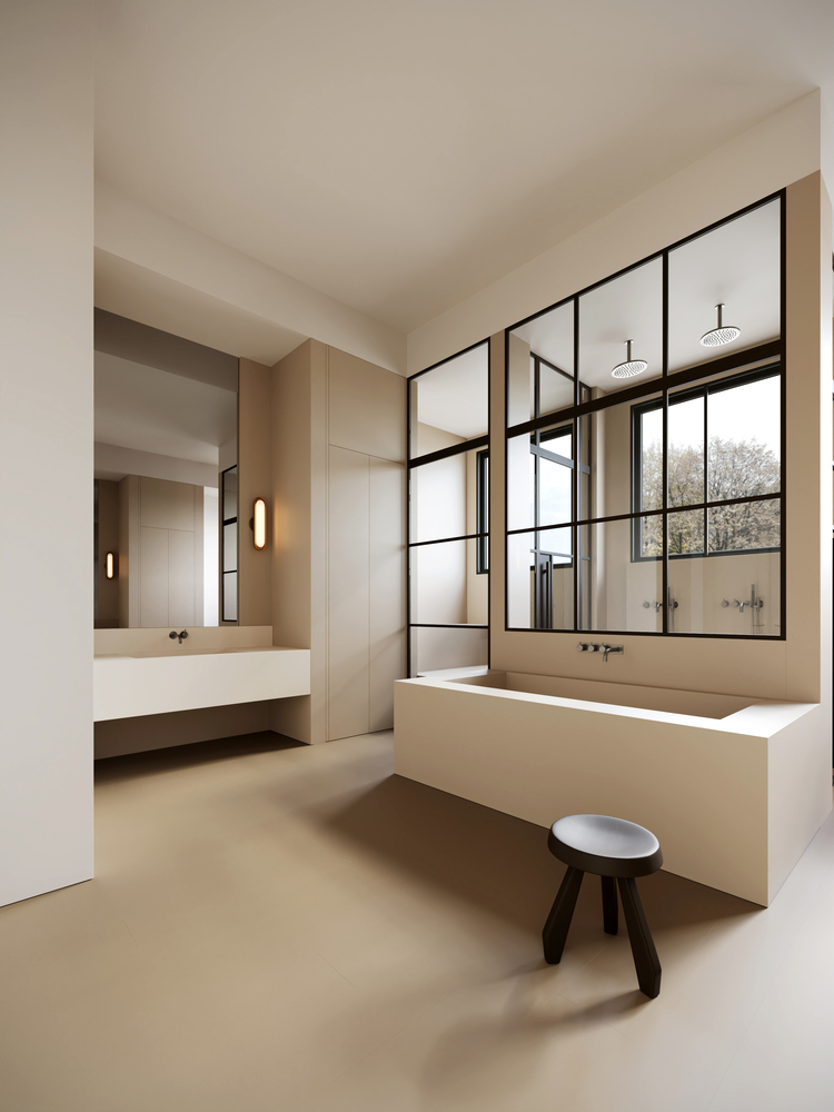 Modern minimalist bathroom with freestanding tub, glass partition, and beige walls.