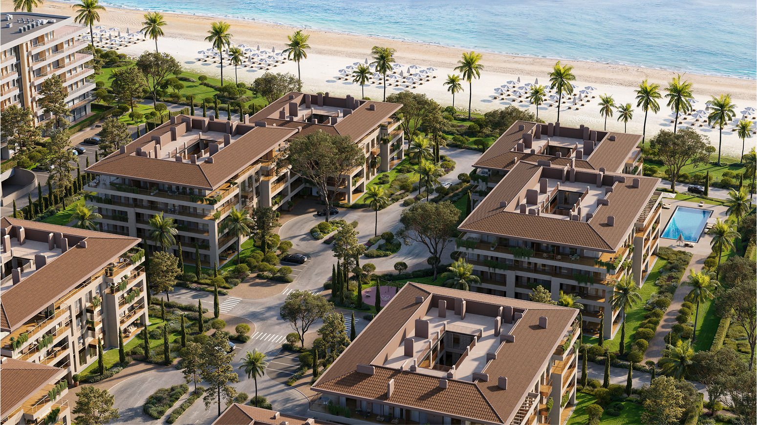 Aerial view of luxury beachfront apartments with lush landscaping and swimming pool.