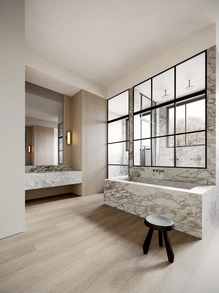 Modern marble bathroom with freestanding bathtub, sleek sink, and large window.