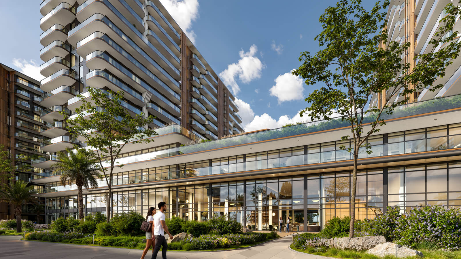 Modern apartment building with landscaped grounds and a couple strolling.