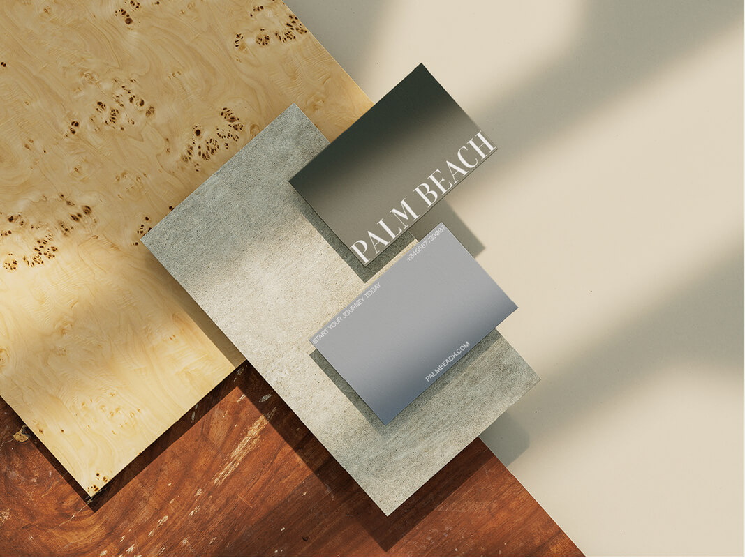 Palm Beach branding: gray and olive green business cards on wood and stone textures.