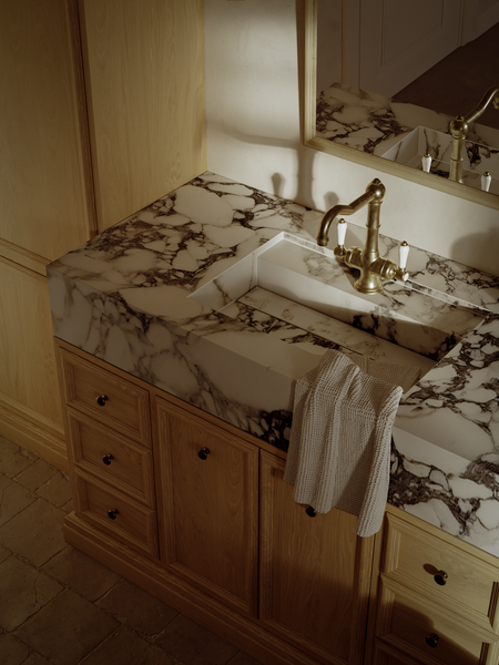 Luxury bathroom vanity with marble countertop and brass faucet, 3D interior rendering.