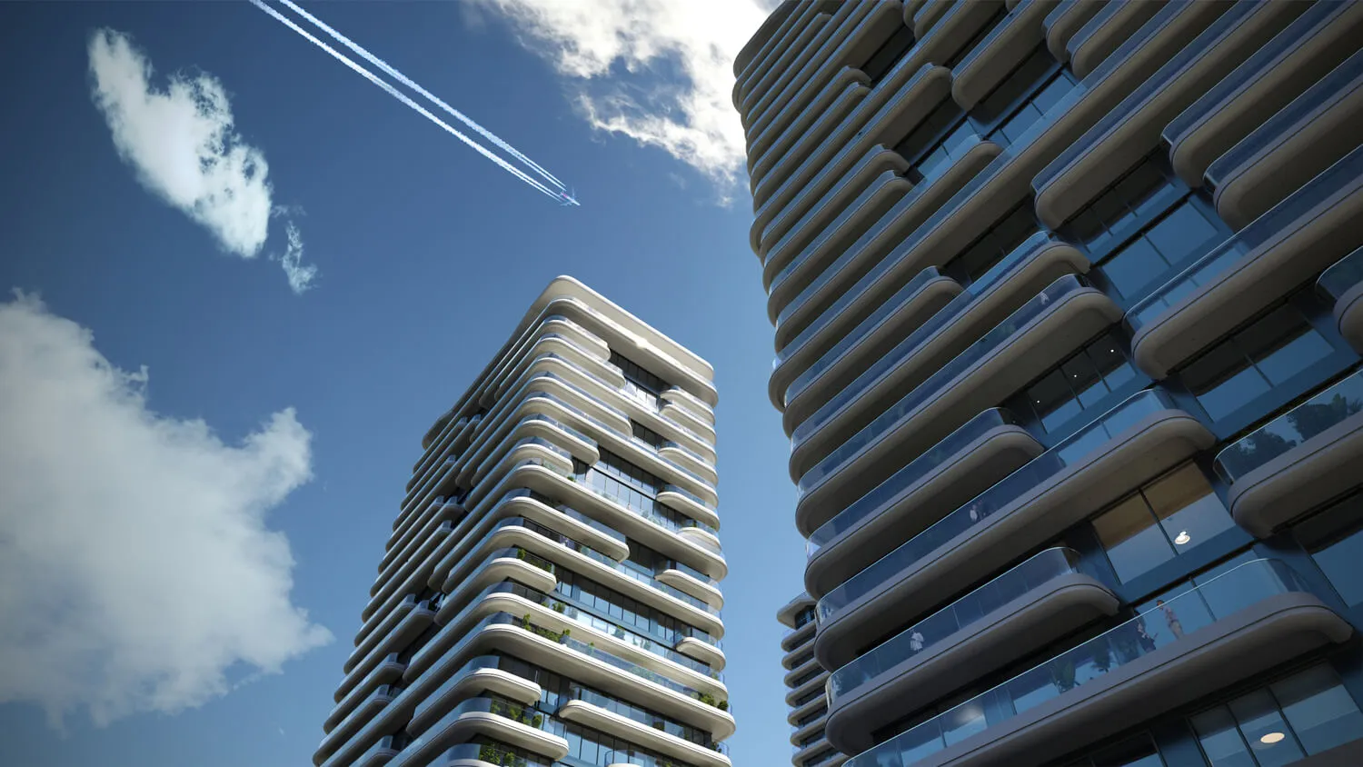 Modern high-rise apartment buildings with curved balconies against a blue sky.