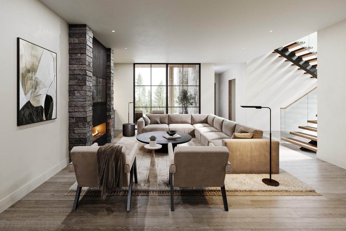 Modern living room with stone fireplace, sectional sofa, and large windows overlooking trees.
