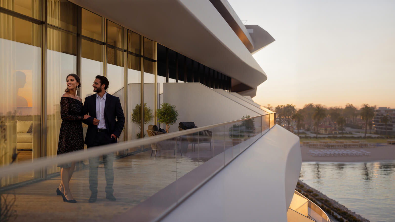 Couple enjoying ocean view from a luxury balcony with modern architecture at sunset. Home.